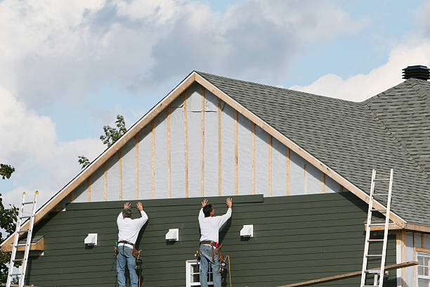 Professional Storm Damage Siding Repair technician working in New Vienna, OH